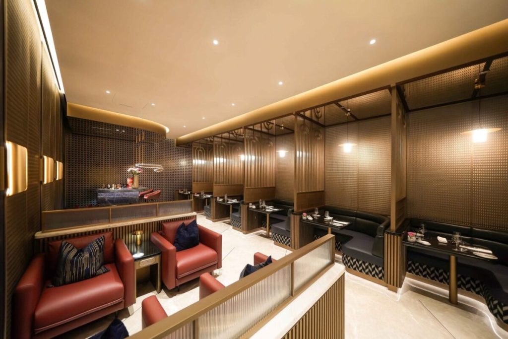Interior of the new British Airways lounge at Dubai Airport with bar, seating, and mirrored ceiling