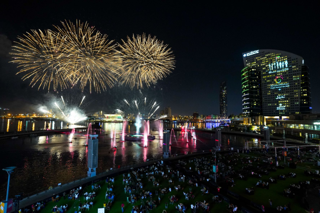 Crowds celebrating the 54th Eid Al Etihad United theme with UAE flags and cultural displays