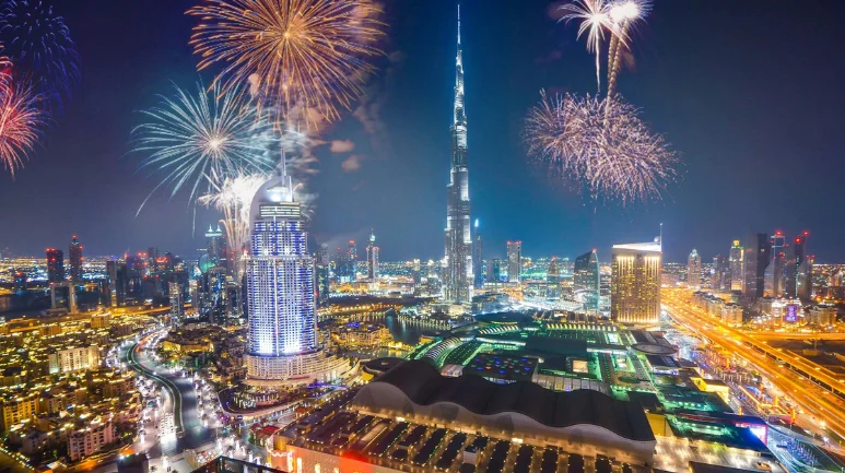 Crowds at Burj Khalifa watching UAE National Day fireworks lighting up Downtown Dubai